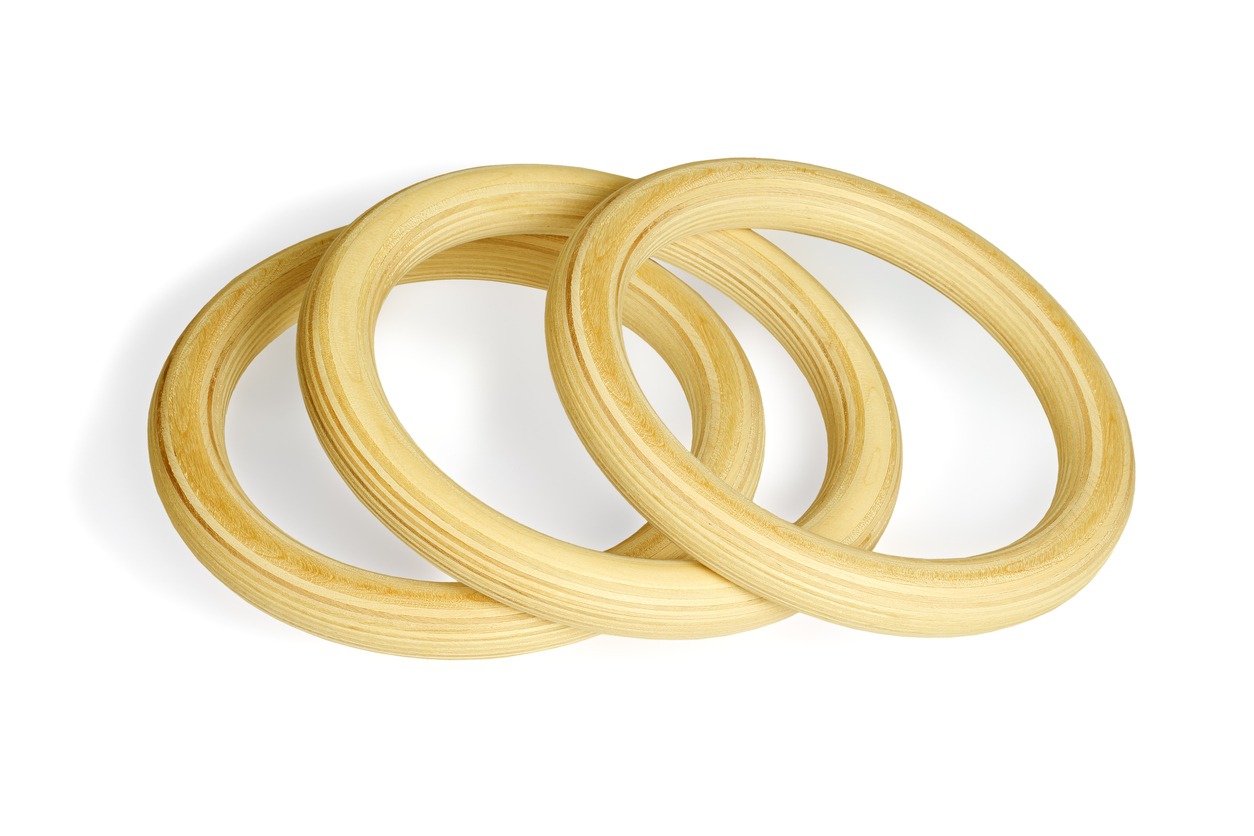 Three Wooden Rings Lying on White Background