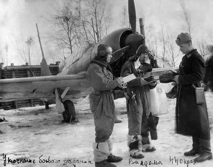 Soviet aviators wearing sheepskin boots, world war II aircraft, snow, trees