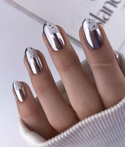 fingers, nails with metallic foil nail polish, edge of a sweater