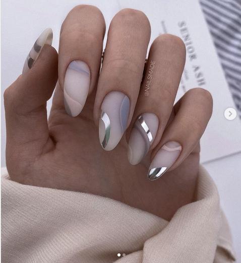 fingers, nails with metallic nail foil, edge of a sweater