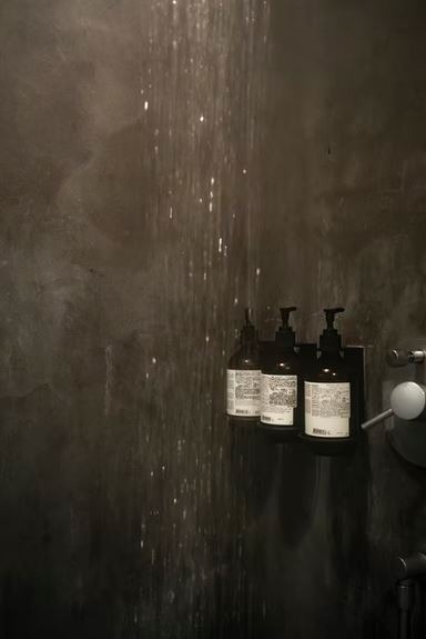 Conditioner bottles on a shower wall