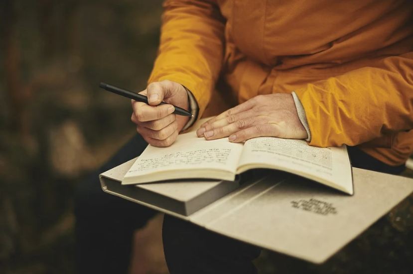 a person writing on their journal