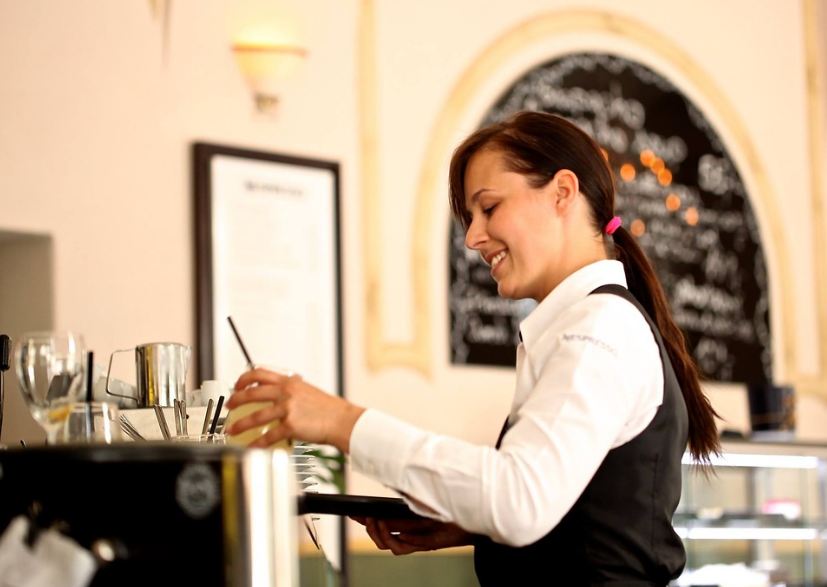waitress at a restaurant preparing to deliver the order