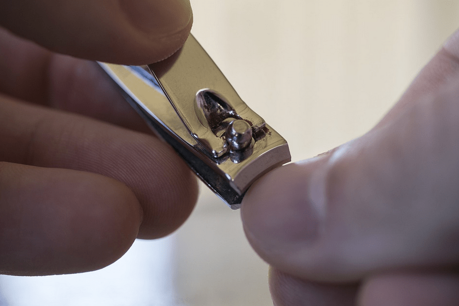 a close up of a person clipping their nails