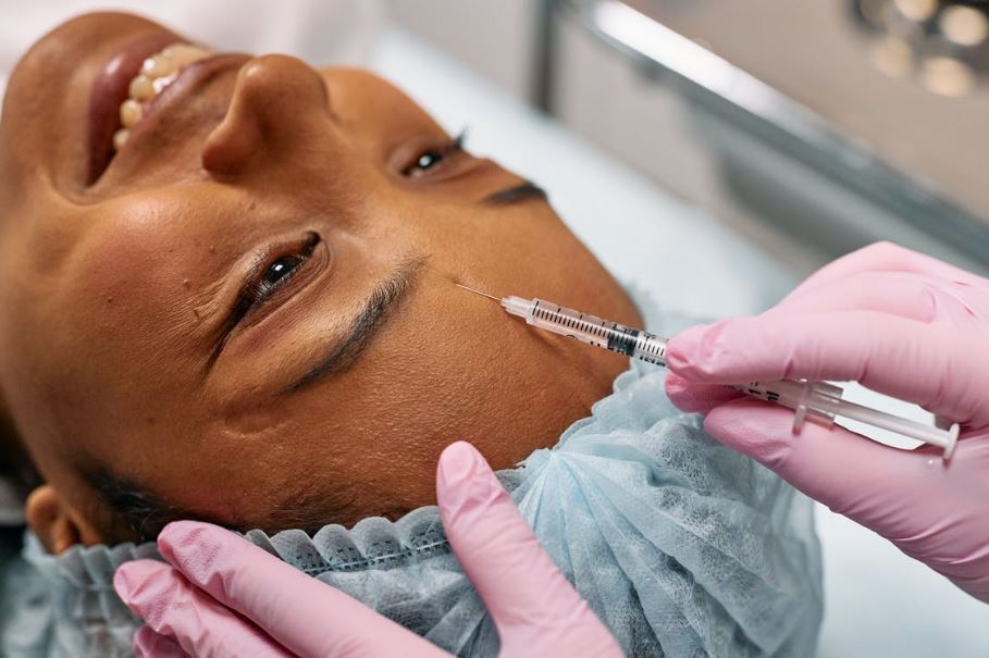 a girl getting Botox on the forehead 