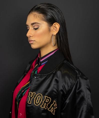 a woman wearing a bomber jacket