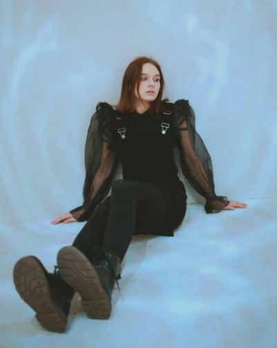a woman wearing leggings as casual wear sitting on the floor