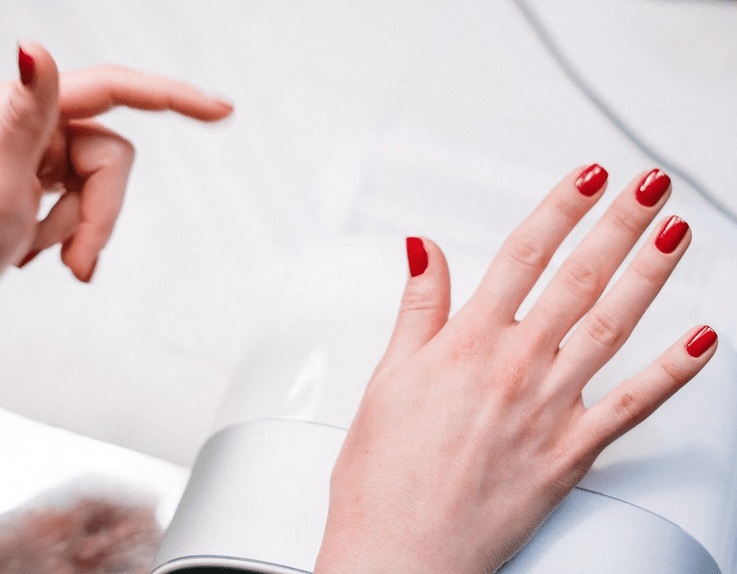 hands with red nail polish