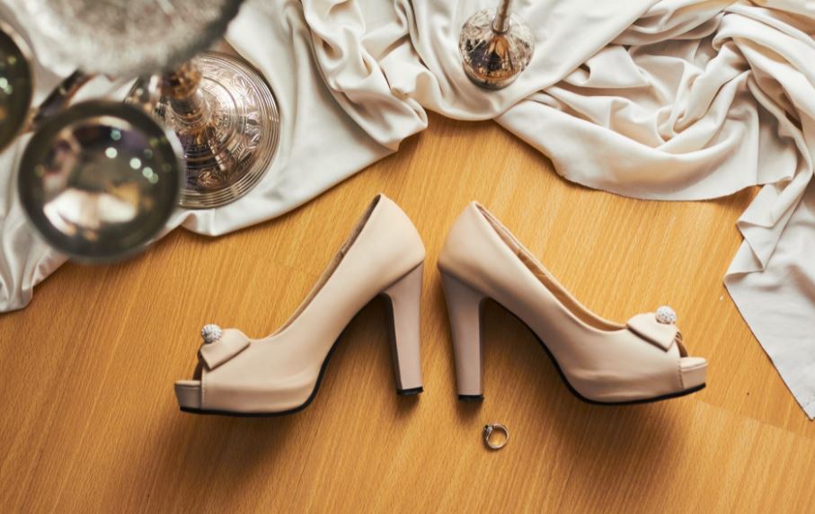 nude colored heels, a ring, ornaments, a cloth