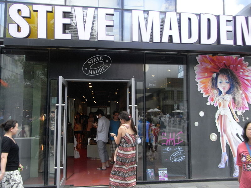 a Steve Madden shop located in Beijing with customers coming in and people passing by