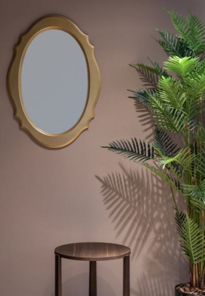 a mirror near a table and a potted plant