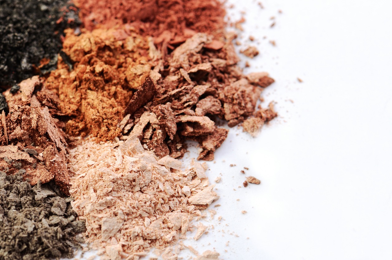 crumbled eyeshadows of different colors on a white background