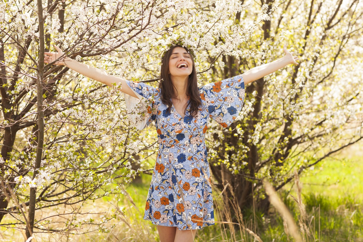 Super happy woman with open arms is enjoying spring spirit!