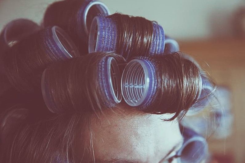 A-woman-with-blue-Velcro-rollers-on-hair