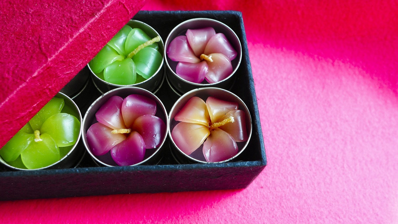Flower-shaped candles in a gift box