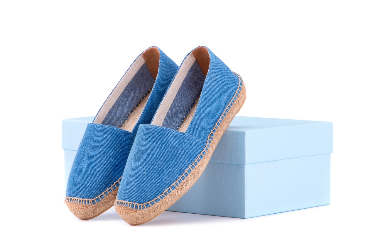 blue espadrilles leaning on a shoe box