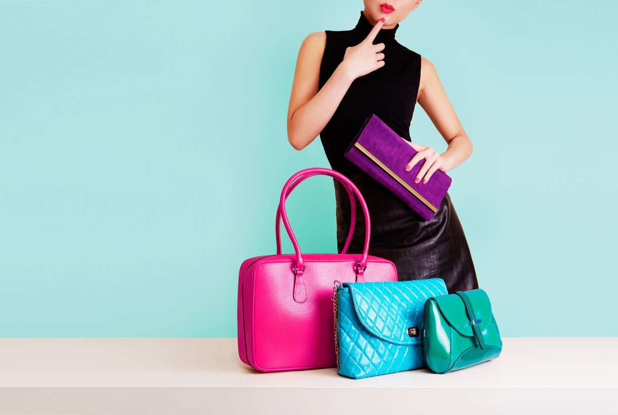 Woman thinking with many colorful bags. Shopping. Fashion image.