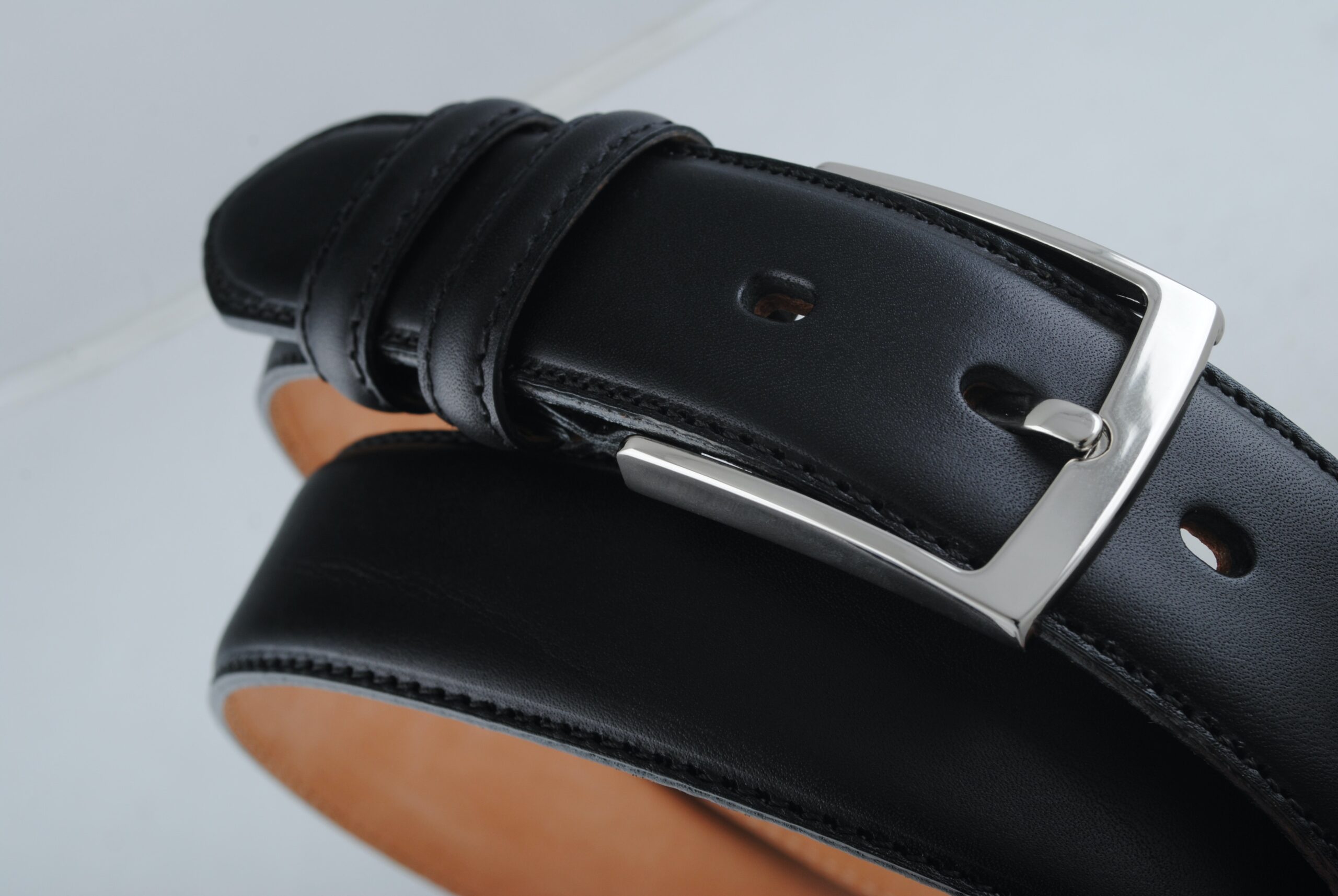 A black leather belt with silver buckle.