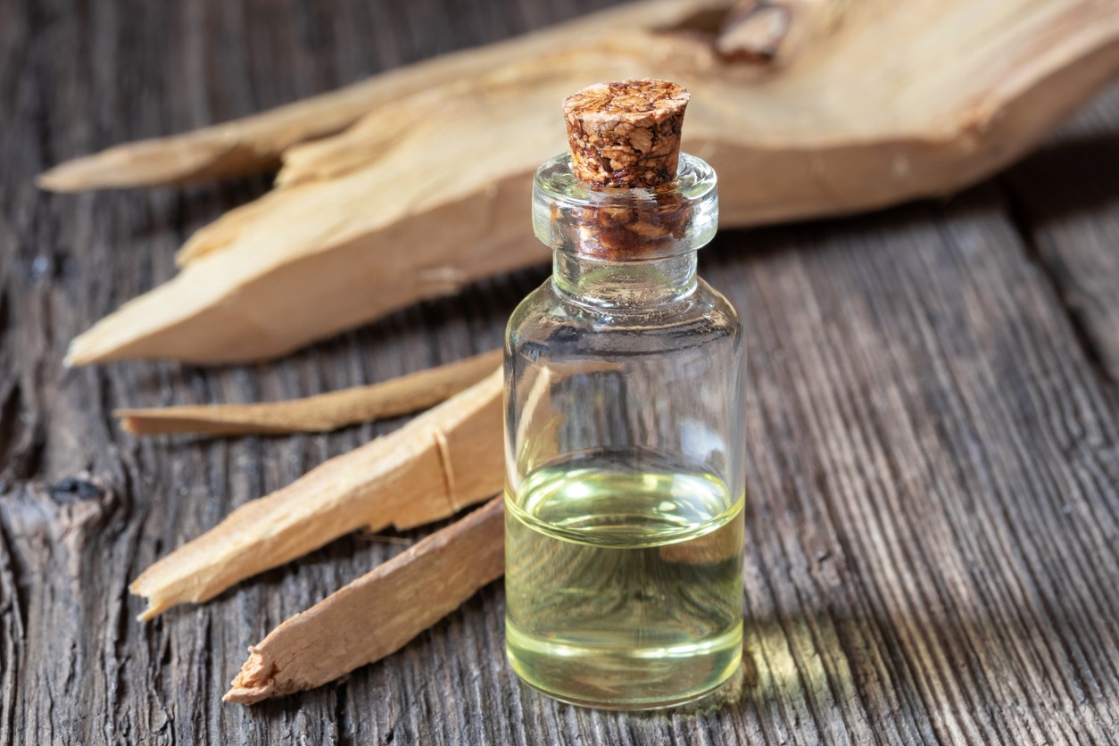 A bottle of sandalwood essential oil with white sandalwood