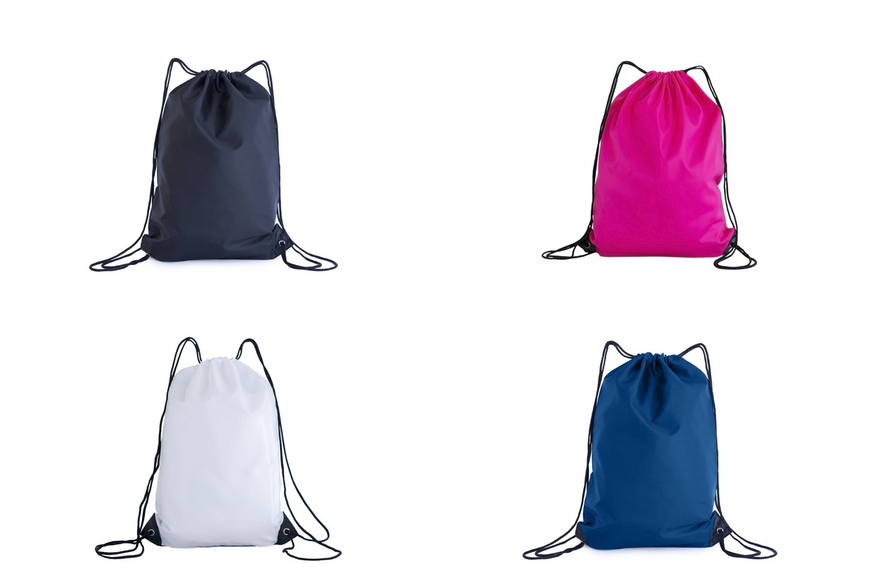 A collection of drawstring bags in the colors of classic blue, pink, white, and black are isolated on a white background