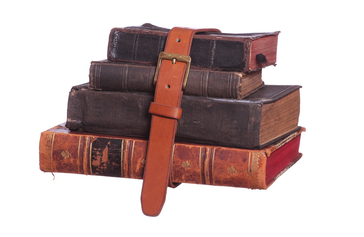 A stock of books bound with leather belt.