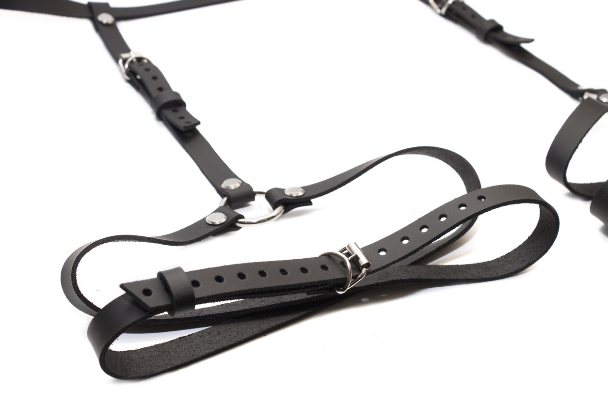 Black suspender belt in a white background