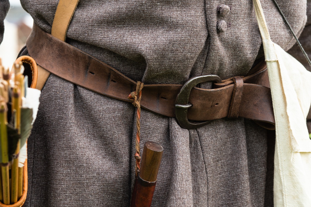 Leather belt, a knife and a quiver with a bunch of arrows are attached to a belt