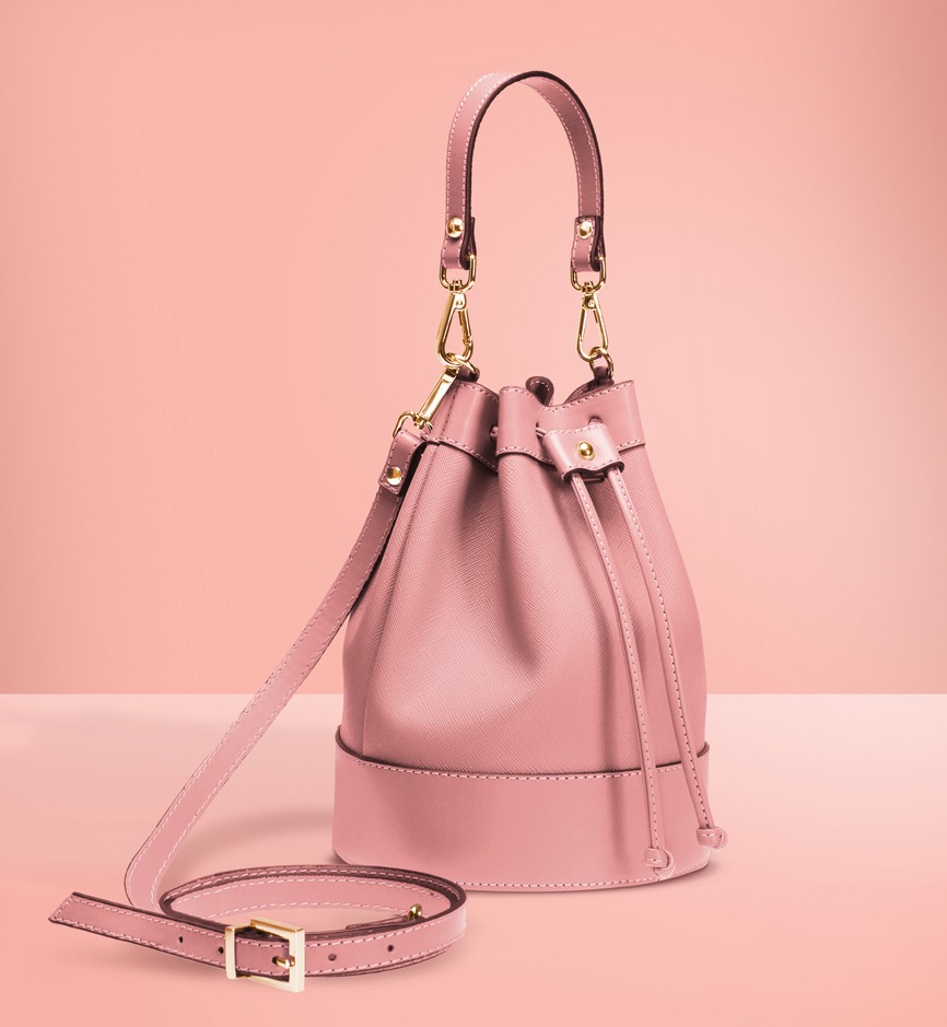 Stylish bucket bag in pink color against a soft pink background.