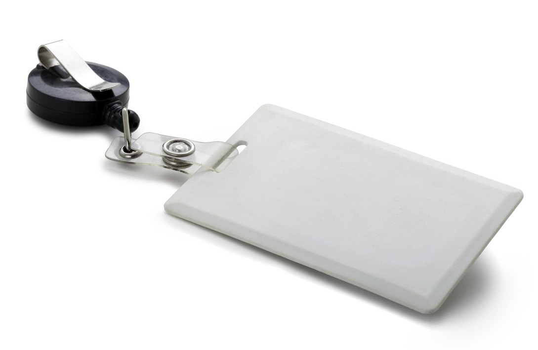 White, plain, rectangular security ID badge with a round black and silvertone clip