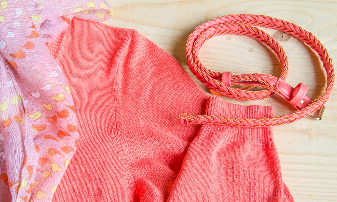 Women’s pink sweater matched with a pink belt.