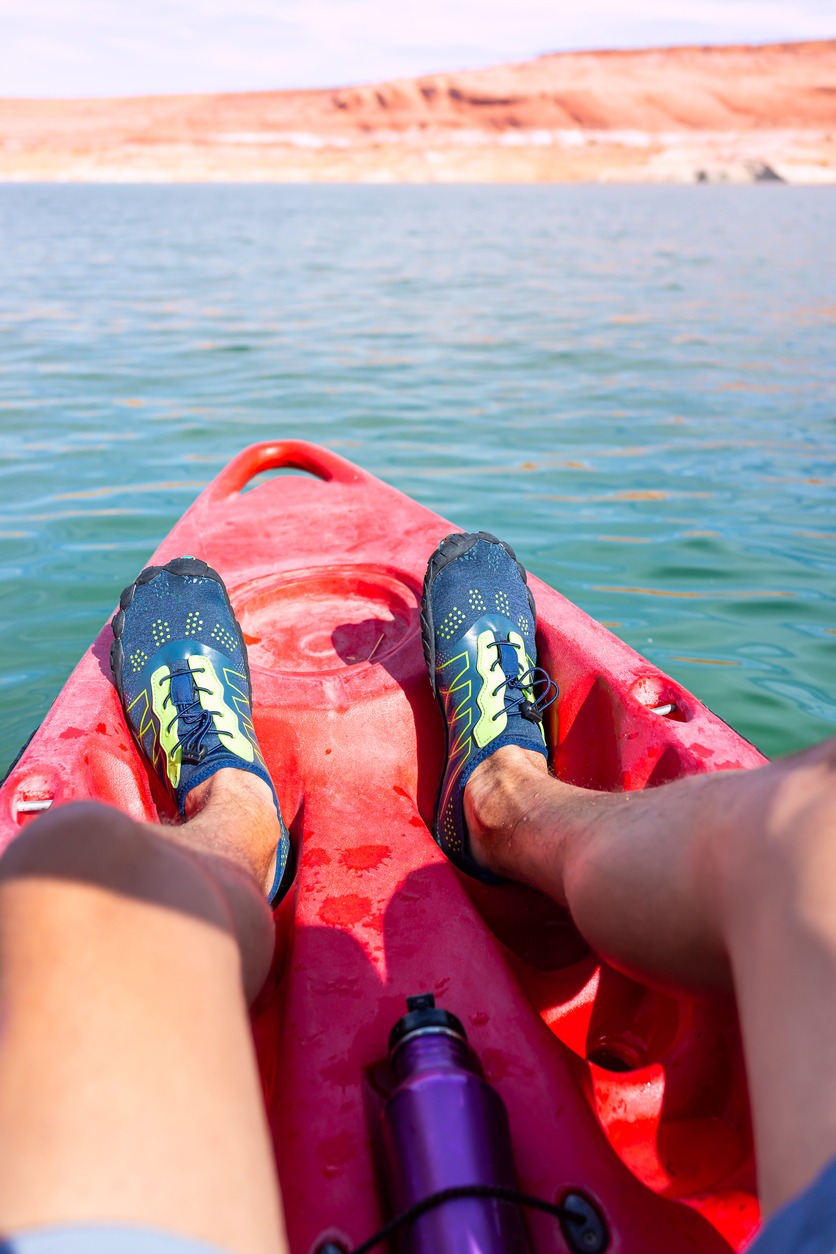 a kayak wearing water shoes