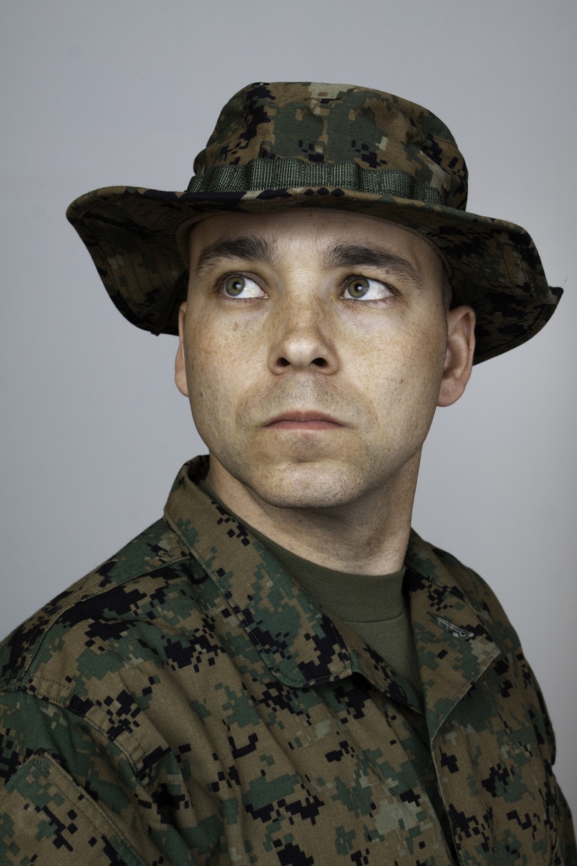 a man wearing a Boonie hat and his military uniform