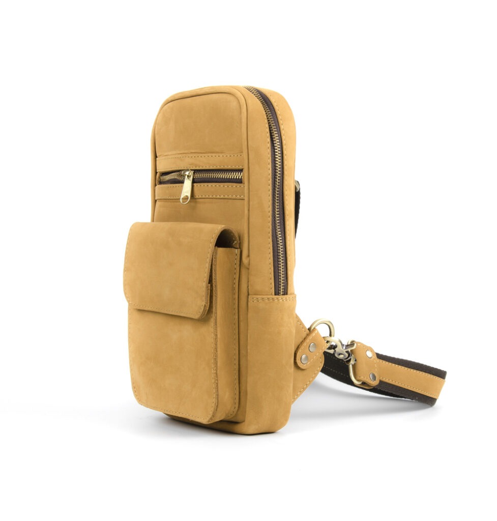 a mustard-leather-colored sling backpack