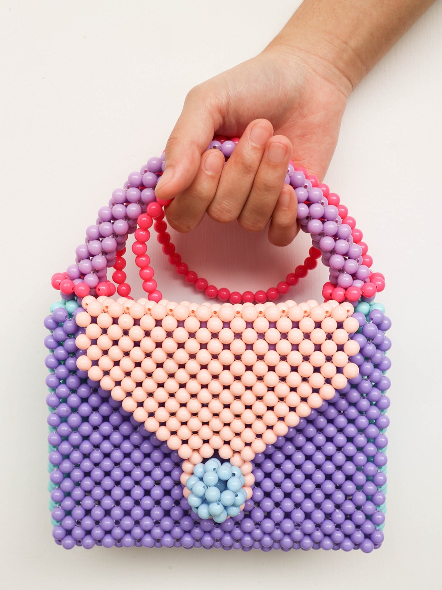 Hand holding beads handbag, elegant and cute to wear