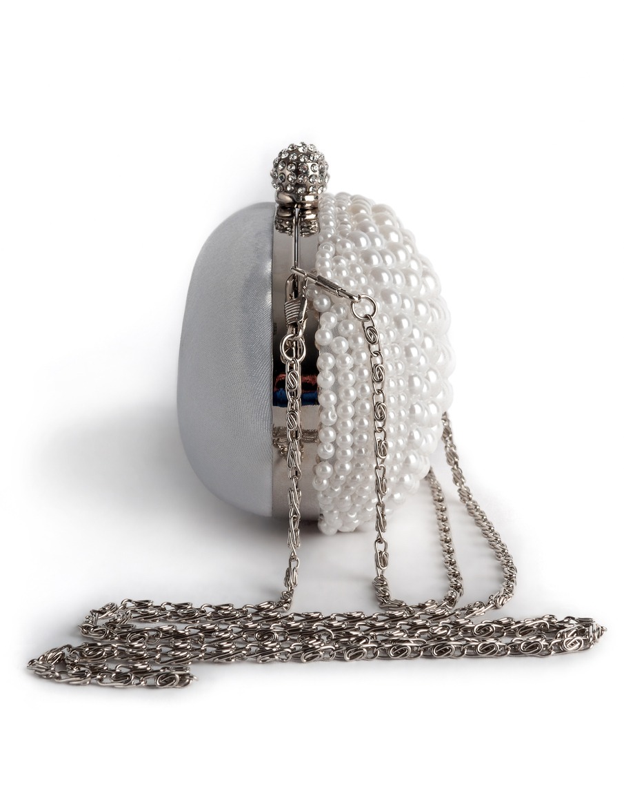 White handbag on a chain decorated with pearls, isolated on a white background