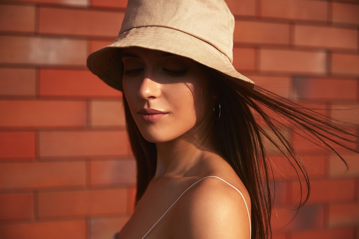 Trendy woman in bucket hat in city