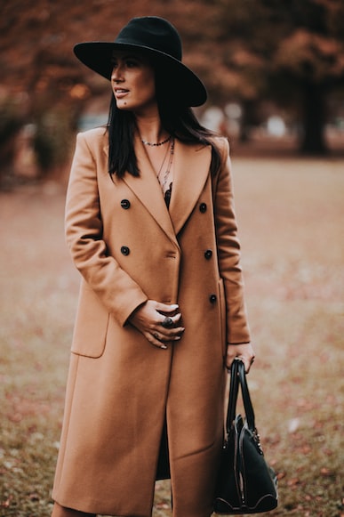 woman wearing brown coat