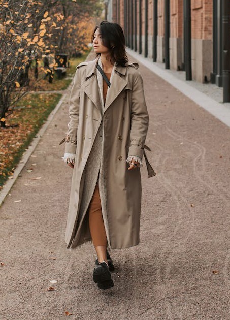 woman wearing full length trench coat