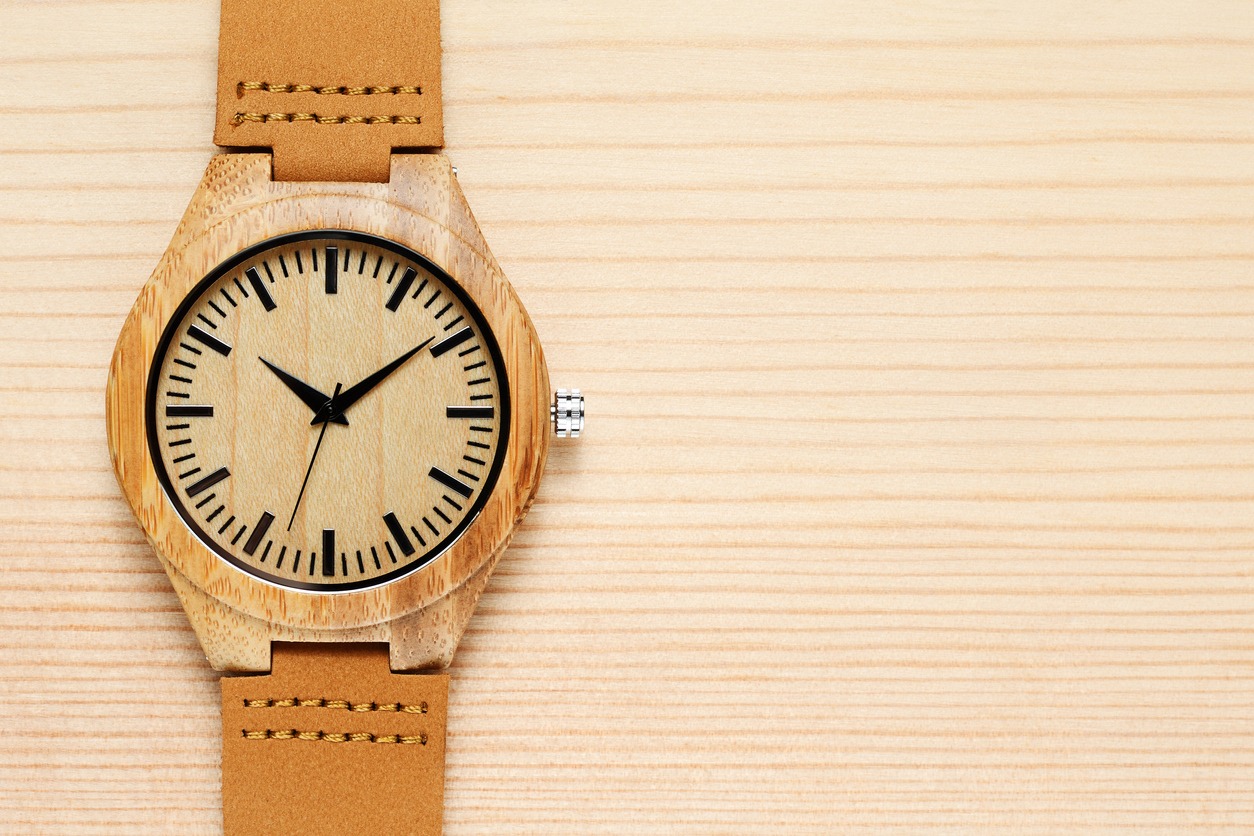 Wooden watch on the wooden background