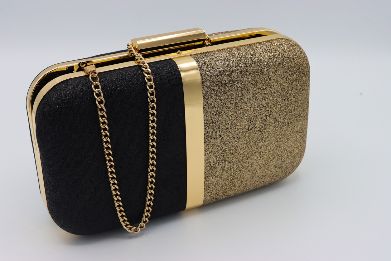A black and gold minaudiere bag