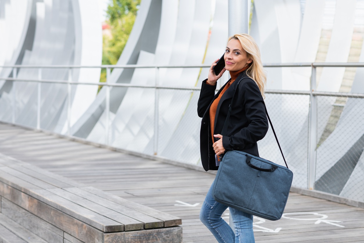 A businesswoman wearing a laptop bag