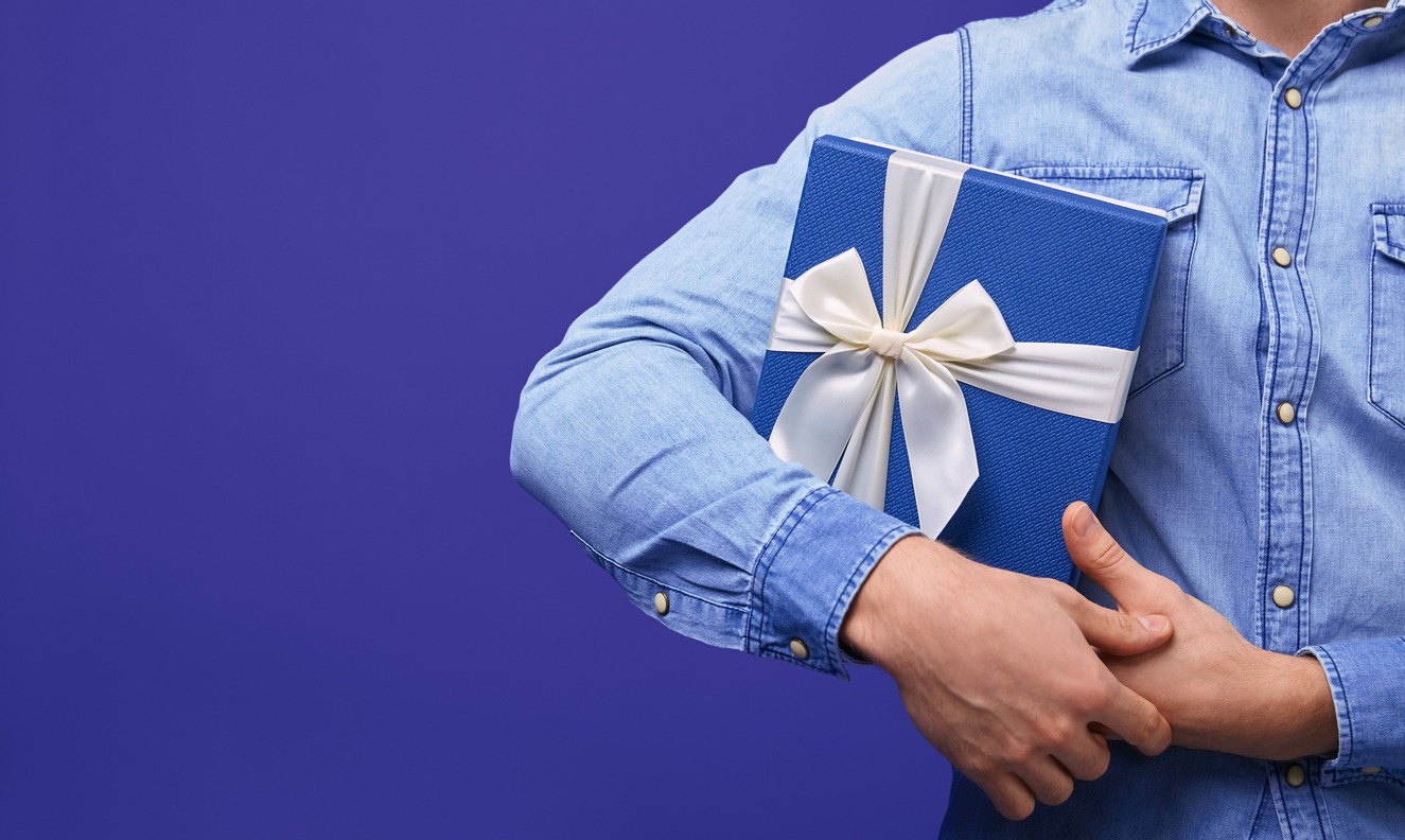 A man holding a blue gift box