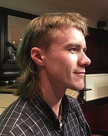 A man with a modern mullet haircut