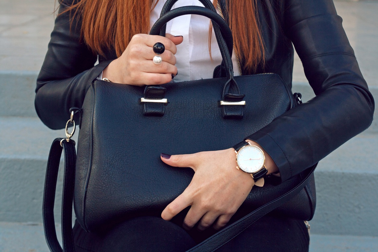A professional lady wearing a black handbag