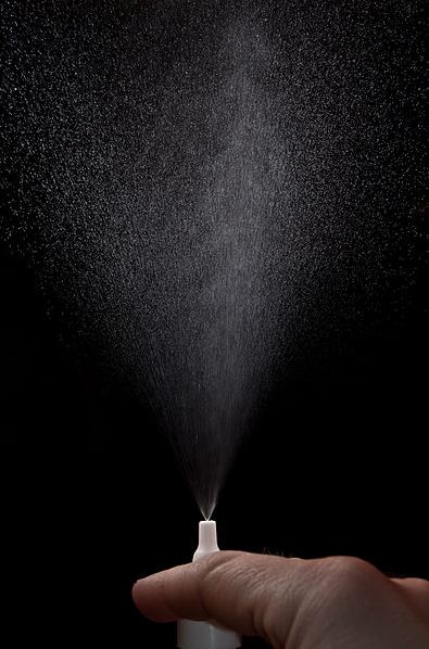 Action-photo-of-a-nasal-spray-on-a-black-background
