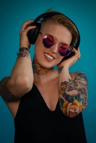 Image-of-a-woman-with-shaved-sides-enjoying-music-on-her-headphones