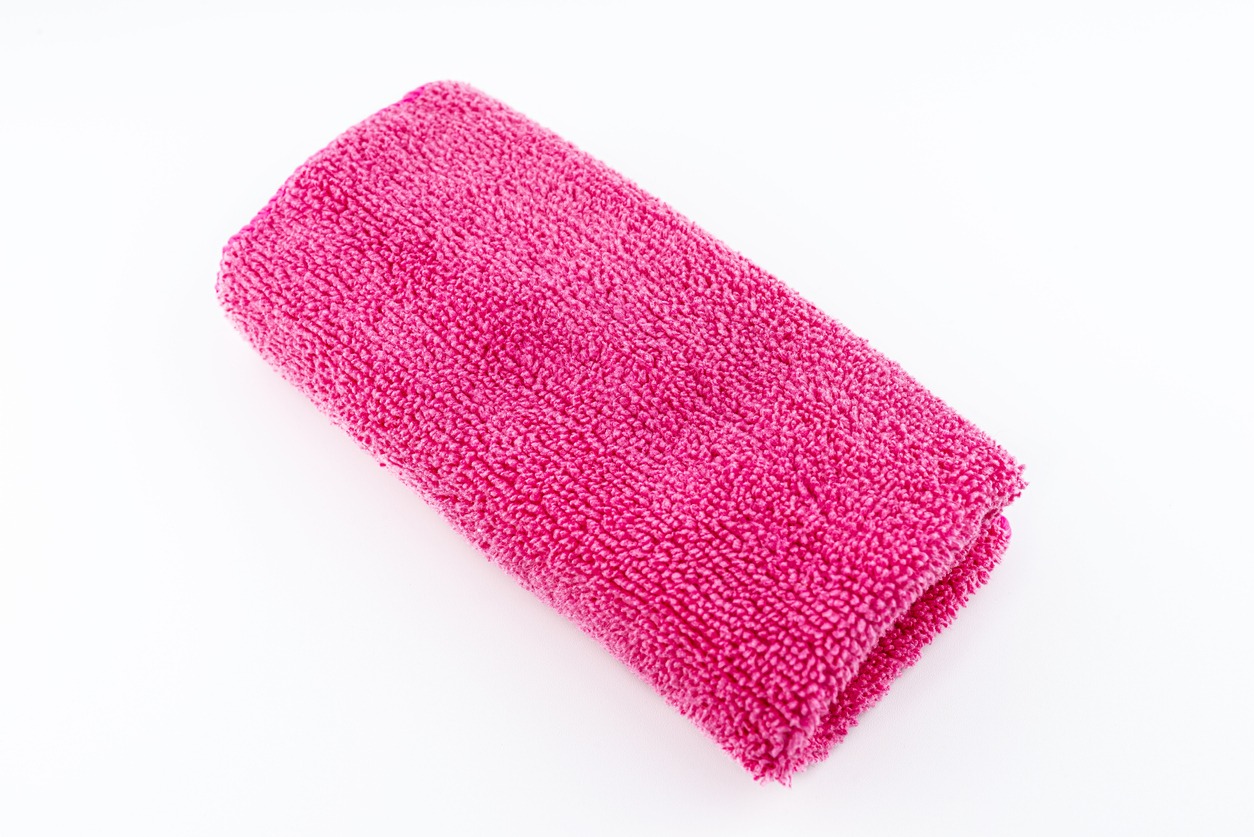 Pink microfiber fabric in the center, isolated on a white background