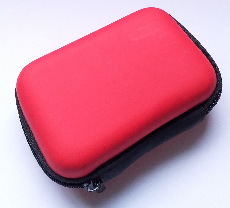 The USB flash drive earphone data cable is kept in a red hard case on a white background
