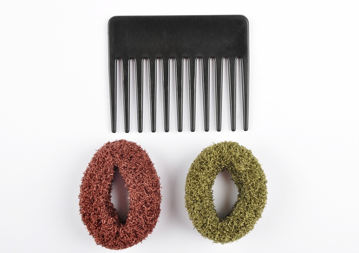a compact black comb and two hair ties