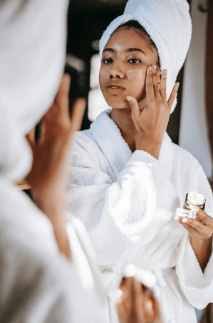 a-woman-applying-cream-on-her-face